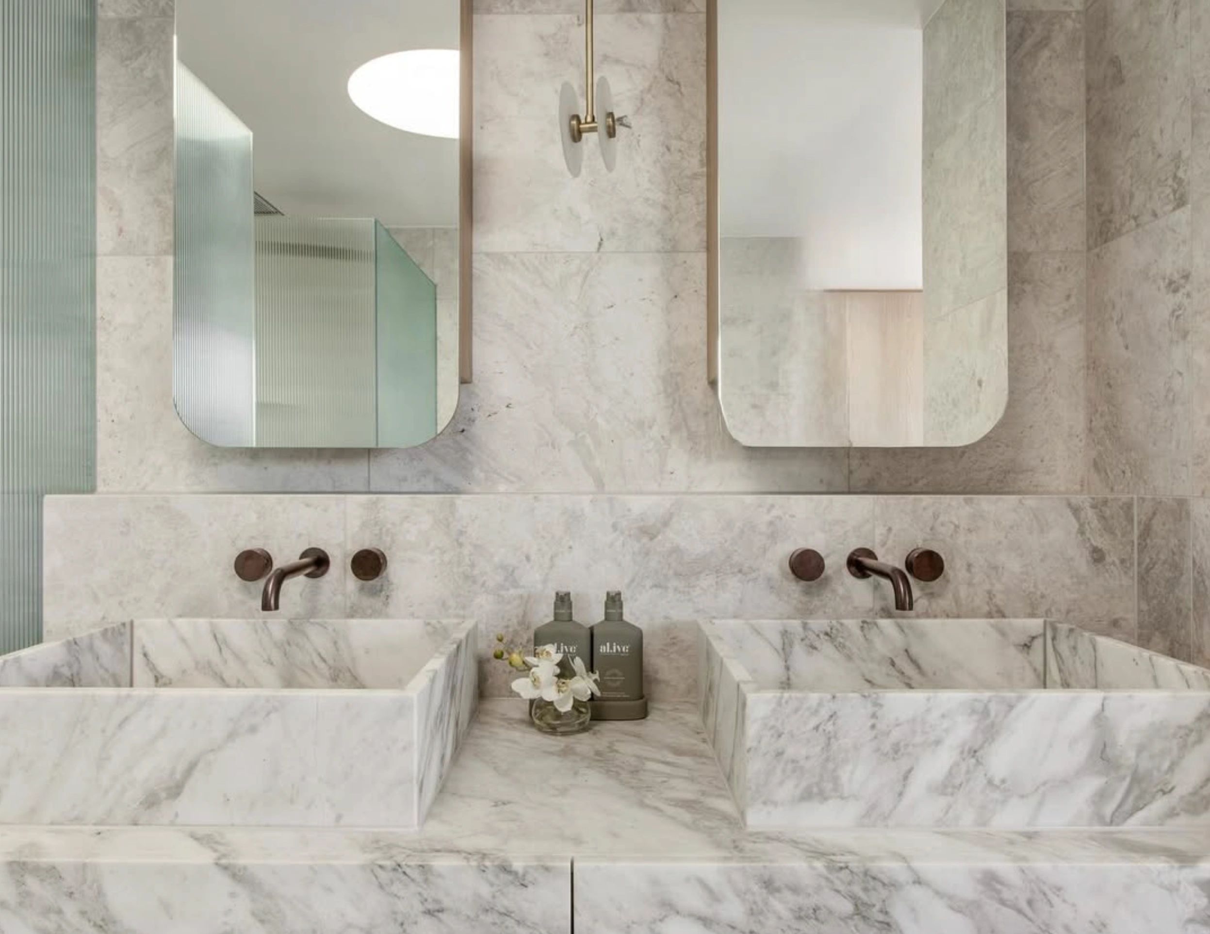 Double vanity white marble vessel sinks brass fixtures